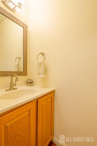 a dining room with wooden floor a chandelier a wooden table and chairs