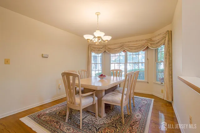 a view of a dining room with furniture and a chandelier