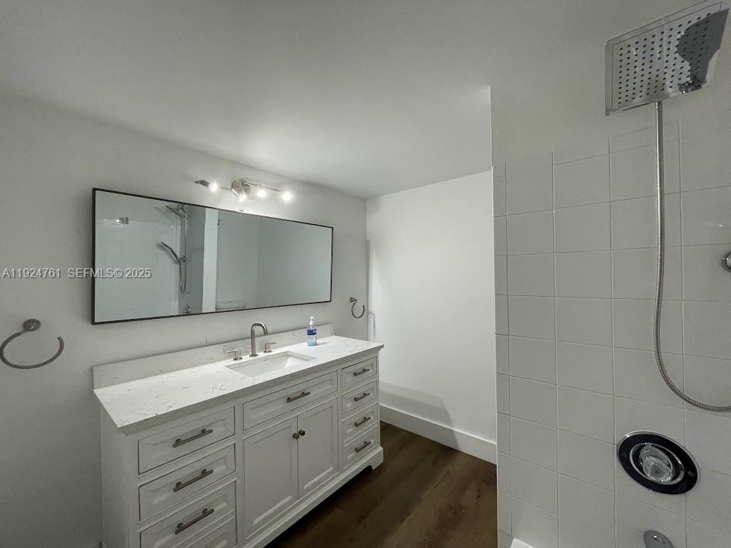 410 South Park Road, Unit 207 Hollywood, FL 33021 - Photo 11 of 47 a bathroom with a double vanity sink and a mirror