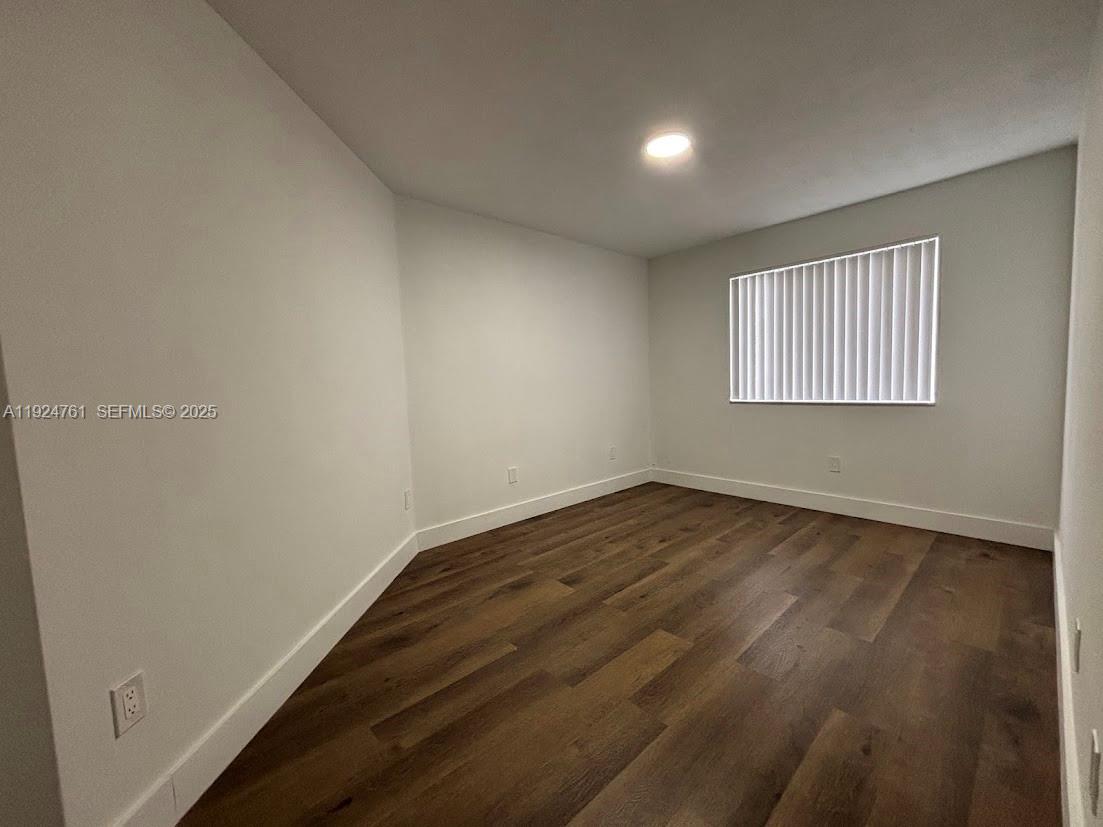 410 South Park Road, Unit 207 Hollywood, FL 33021 - Photo 22 of 47 an empty room with wooden floor and windows