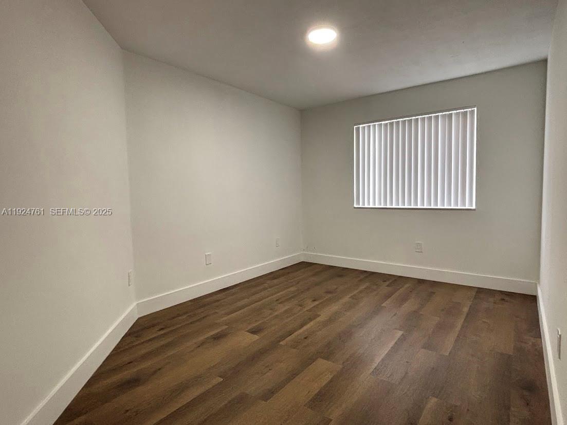 410 South Park Road, Unit 207 Hollywood, FL 33021 - Photo 27 of 47 an empty room with wooden floor and windows