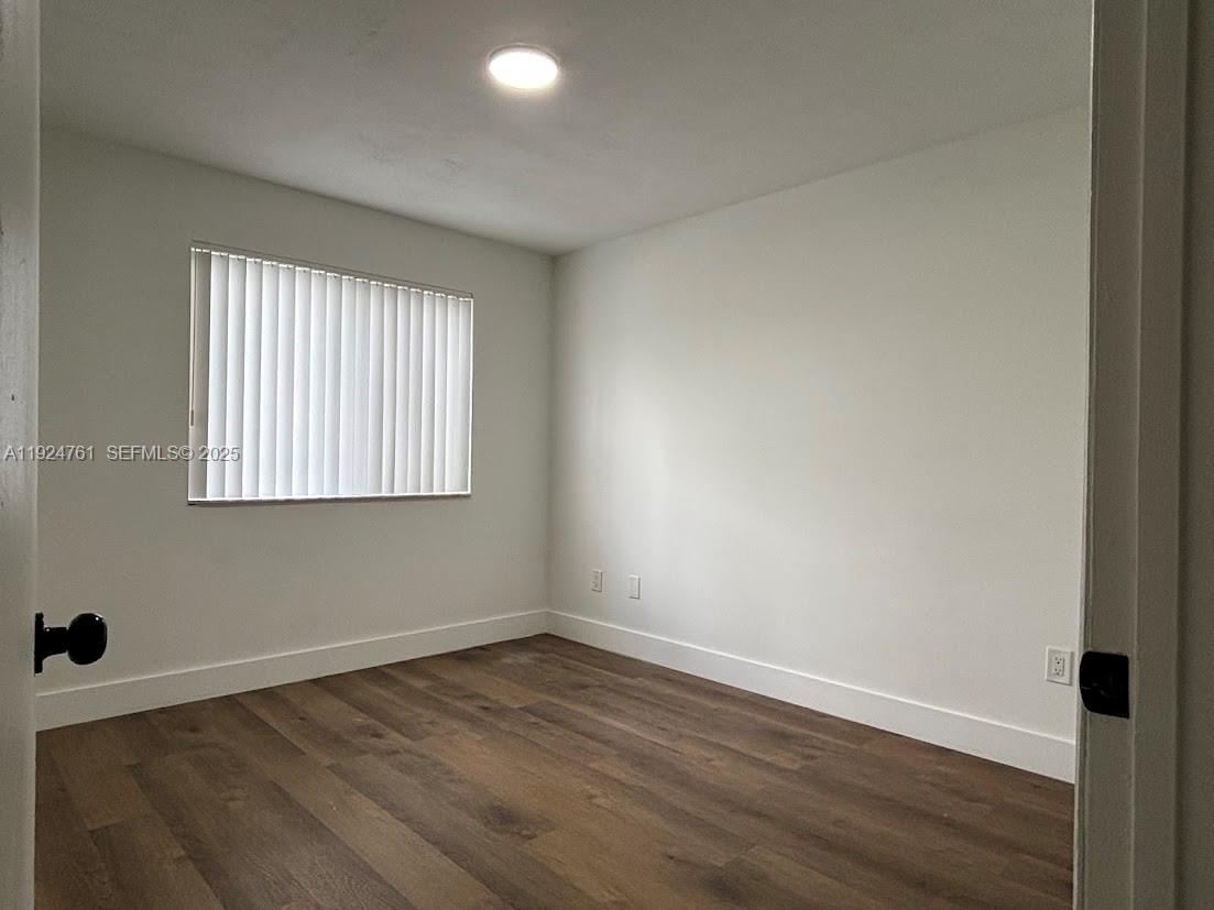 410 South Park Road, Unit 207 Hollywood, FL 33021 - Photo 28 of 47 wooden floor in an empty room with a window