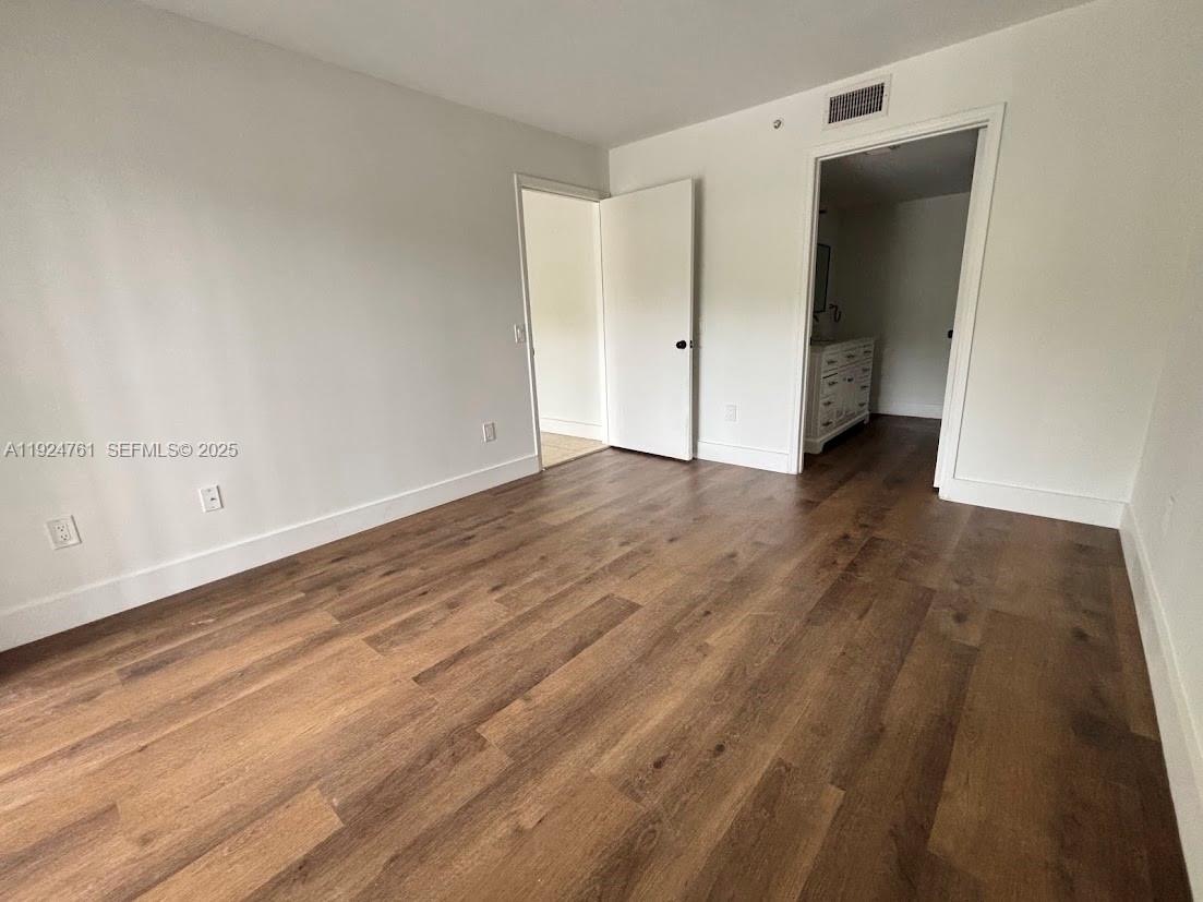 410 South Park Road, Unit 207 Hollywood, FL 33021 - Photo 30 of 47 an empty room with wooden floor and closet