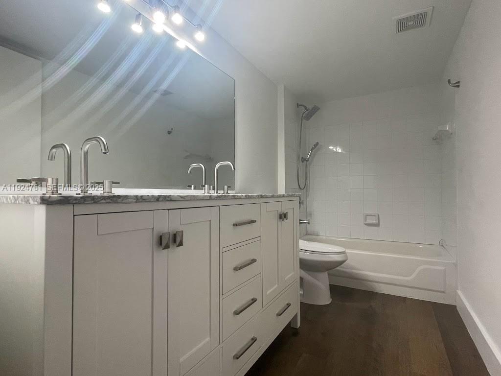 410 South Park Road, Unit 207 Hollywood, FL 33021 - Photo 31 of 47 a bathroom with a double vanity sink toilet and a tub