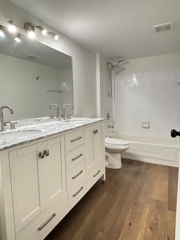 410 South Park Road, Unit 207 Hollywood, FL 33021 - Photo 32 of 47 a bathroom with a double vanity sink toilet mirror and bathtub