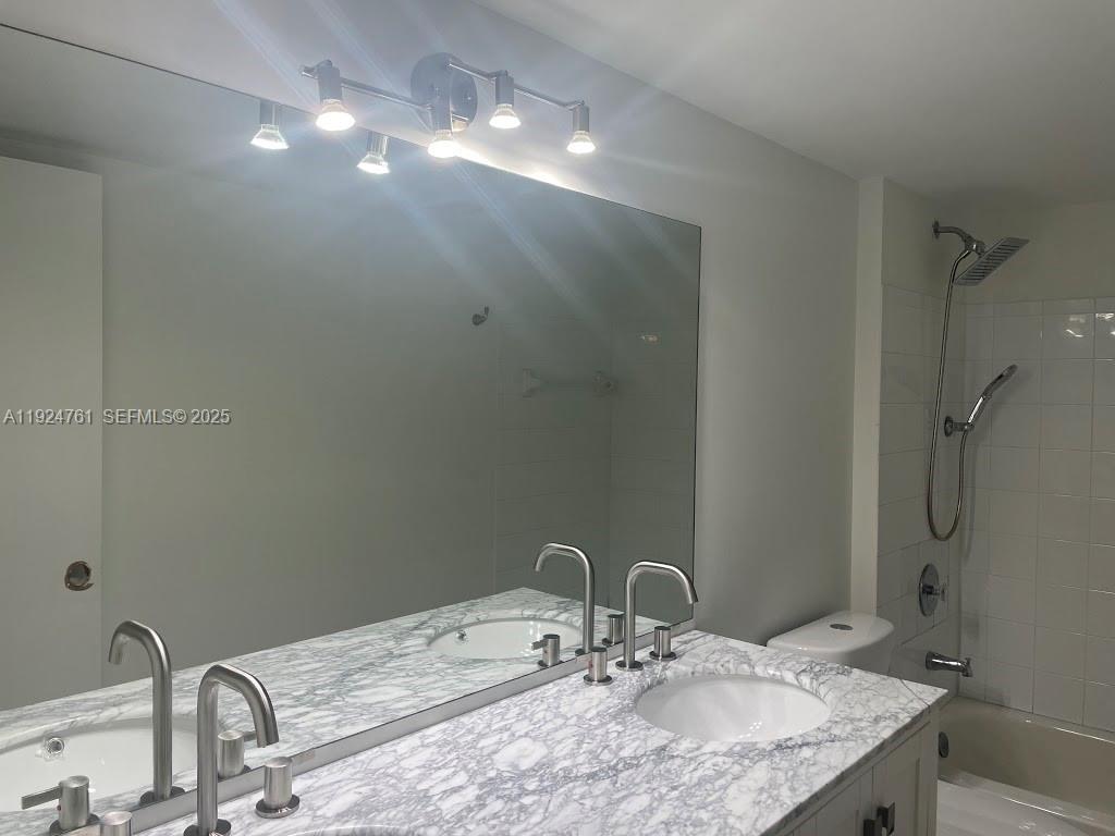 410 South Park Road, Unit 207 Hollywood, FL 33021 - Photo 34 of 47 a bathroom with a sink and a mirror