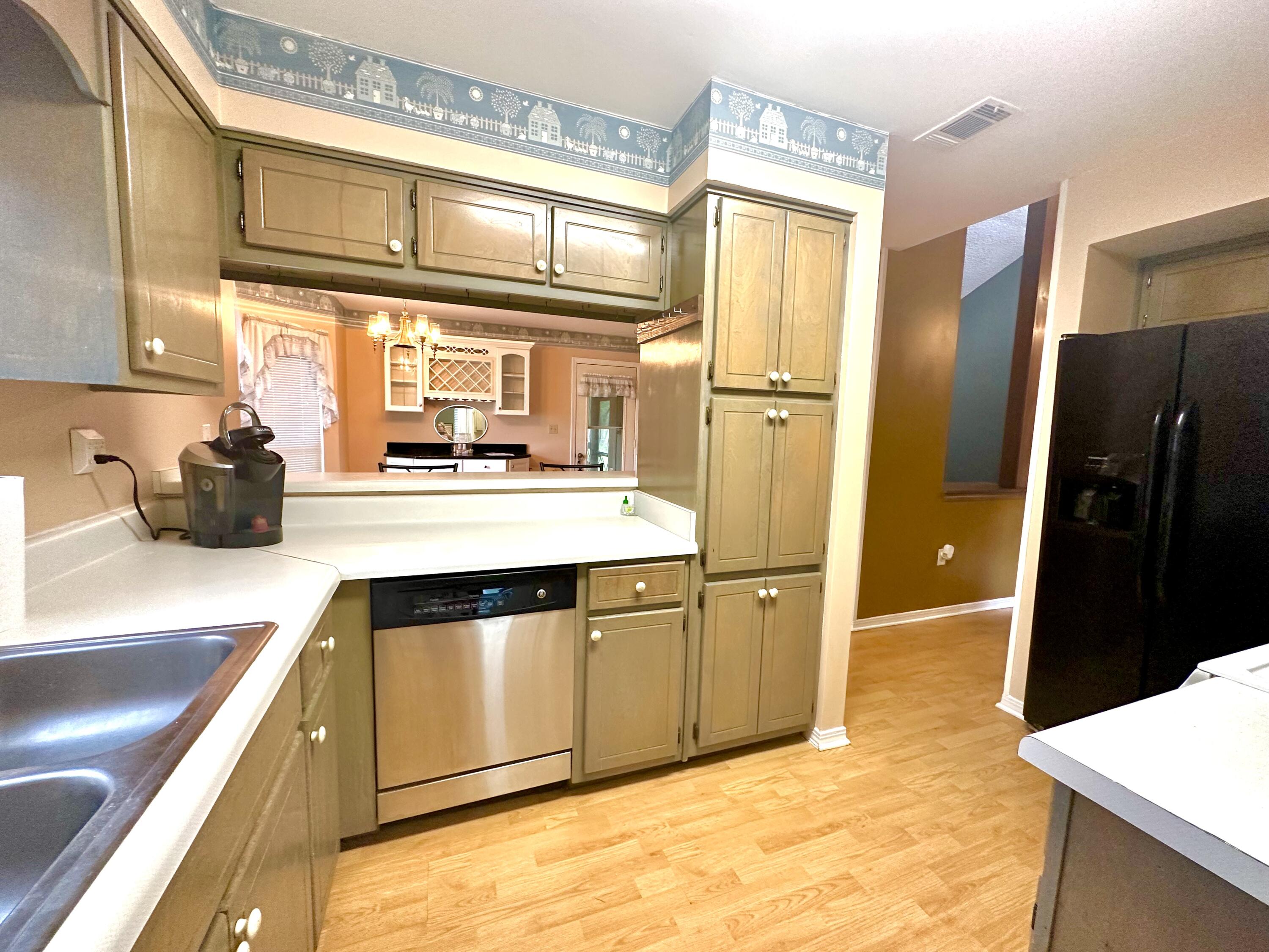 128 Dolphin Cove Freeport, FL 32439 - Photo 14 of 36 a kitchen with stainless steel appliances a refrigerator and a sink