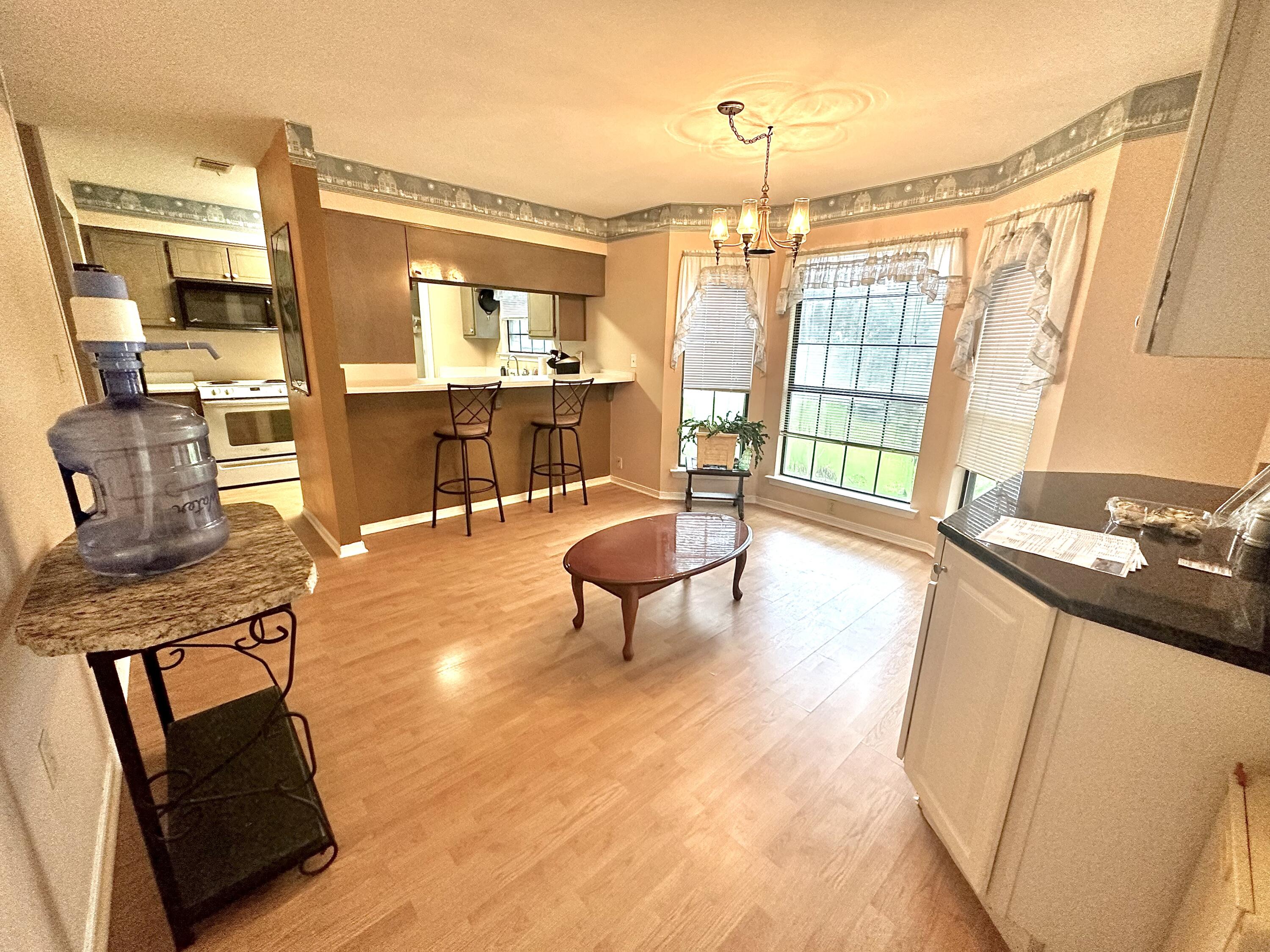 128 Dolphin Cove Freeport, FL 32439 - Photo 15 of 36 a living room with furniture a flat screen tv and a floor to ceiling window