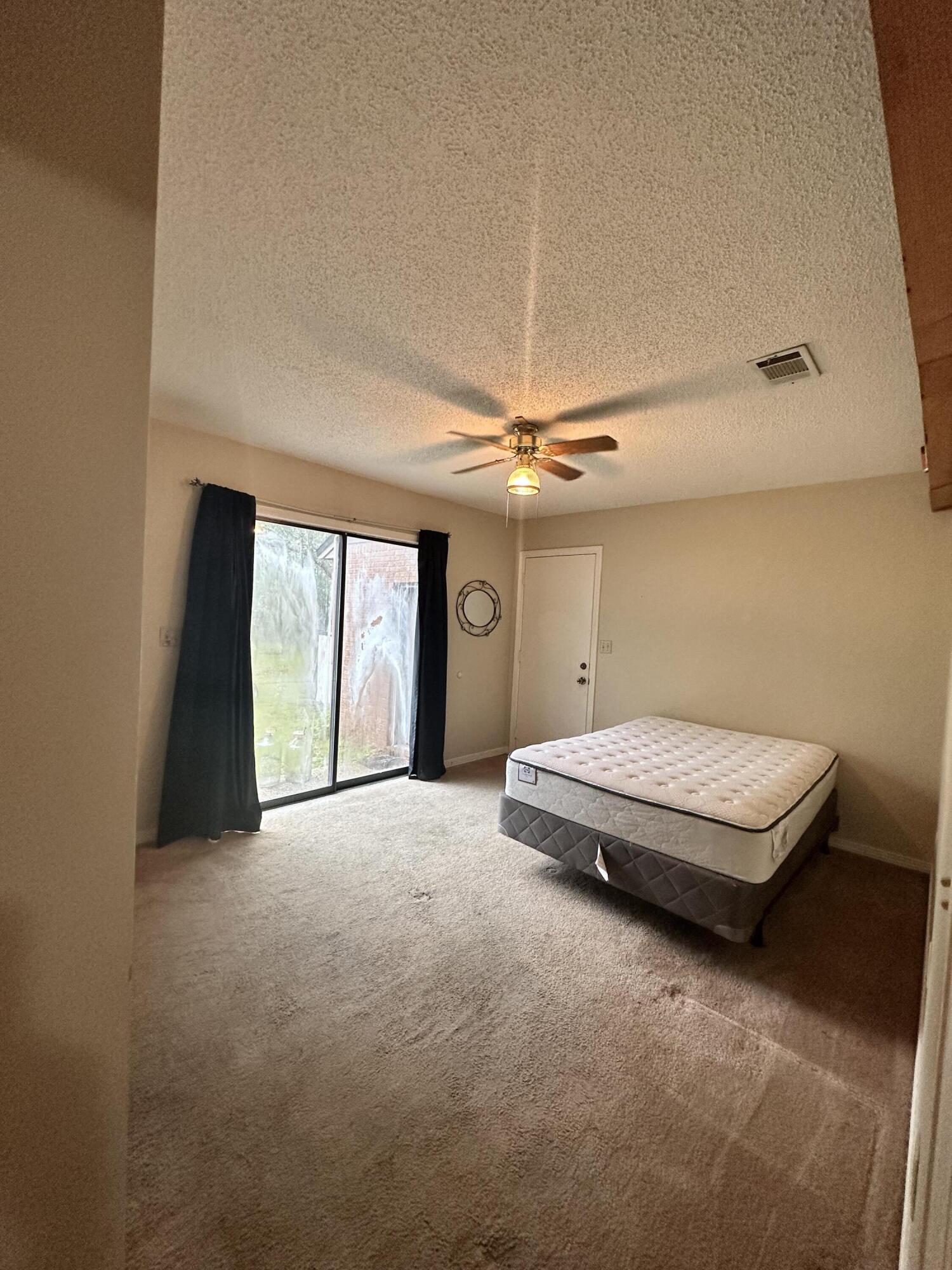 128 Dolphin Cove Freeport, FL 32439 - Photo 19 of 36 a livingroom with a ceiling fan and window