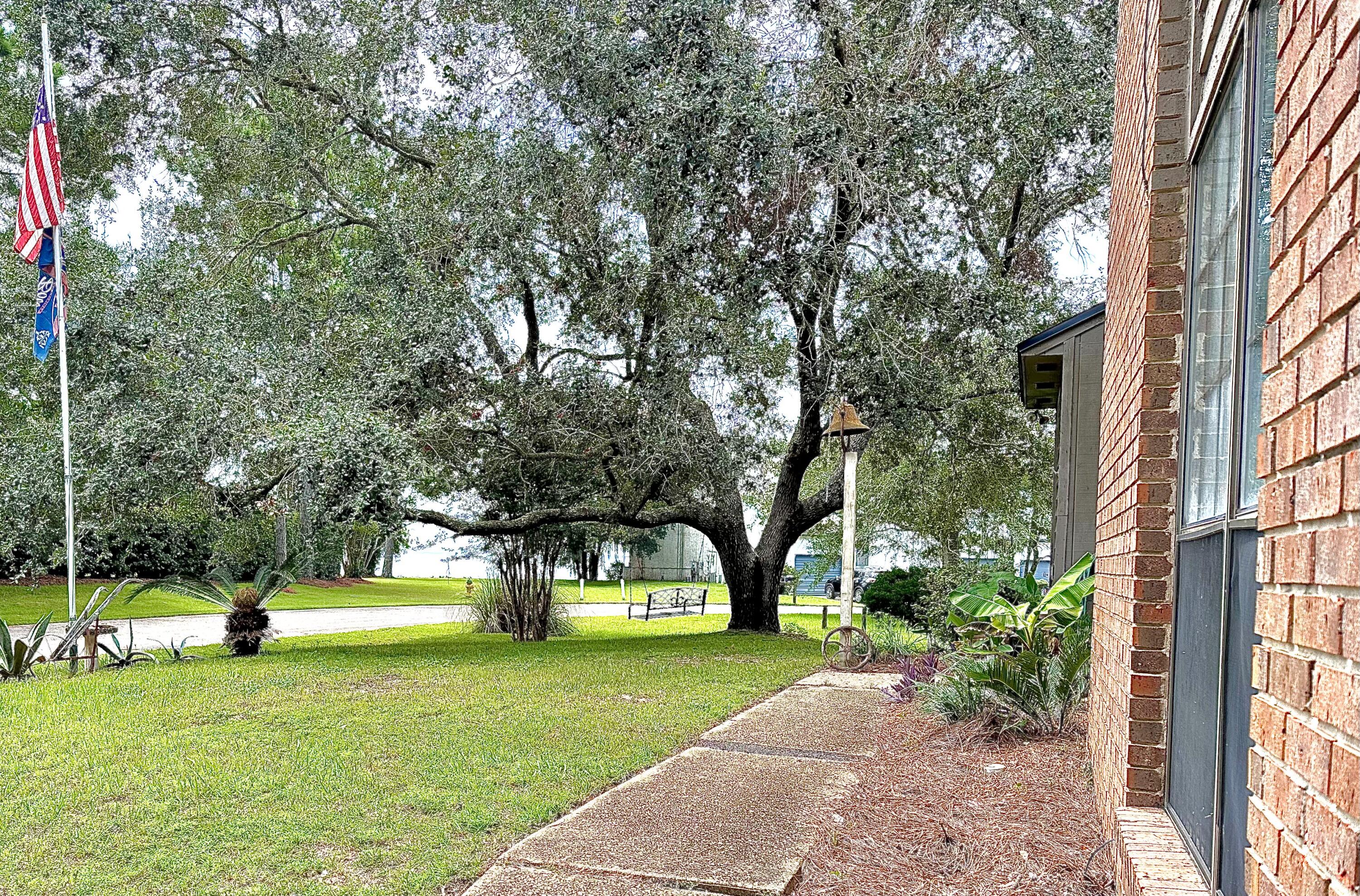 128 Dolphin Cove Freeport, FL 32439 - Photo 6 of 36 a house with trees in front of it