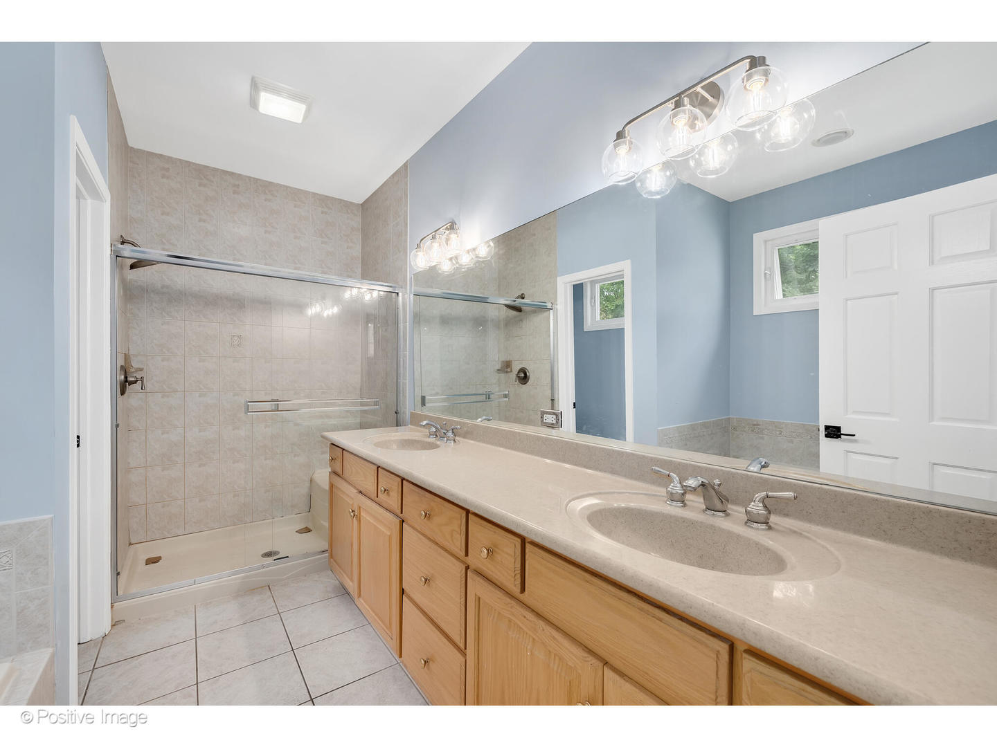 1103 Compass Court Naperville, IL 60540 - Photo 11 of 19 a bathroom with a sink a shower a mirror and a shower