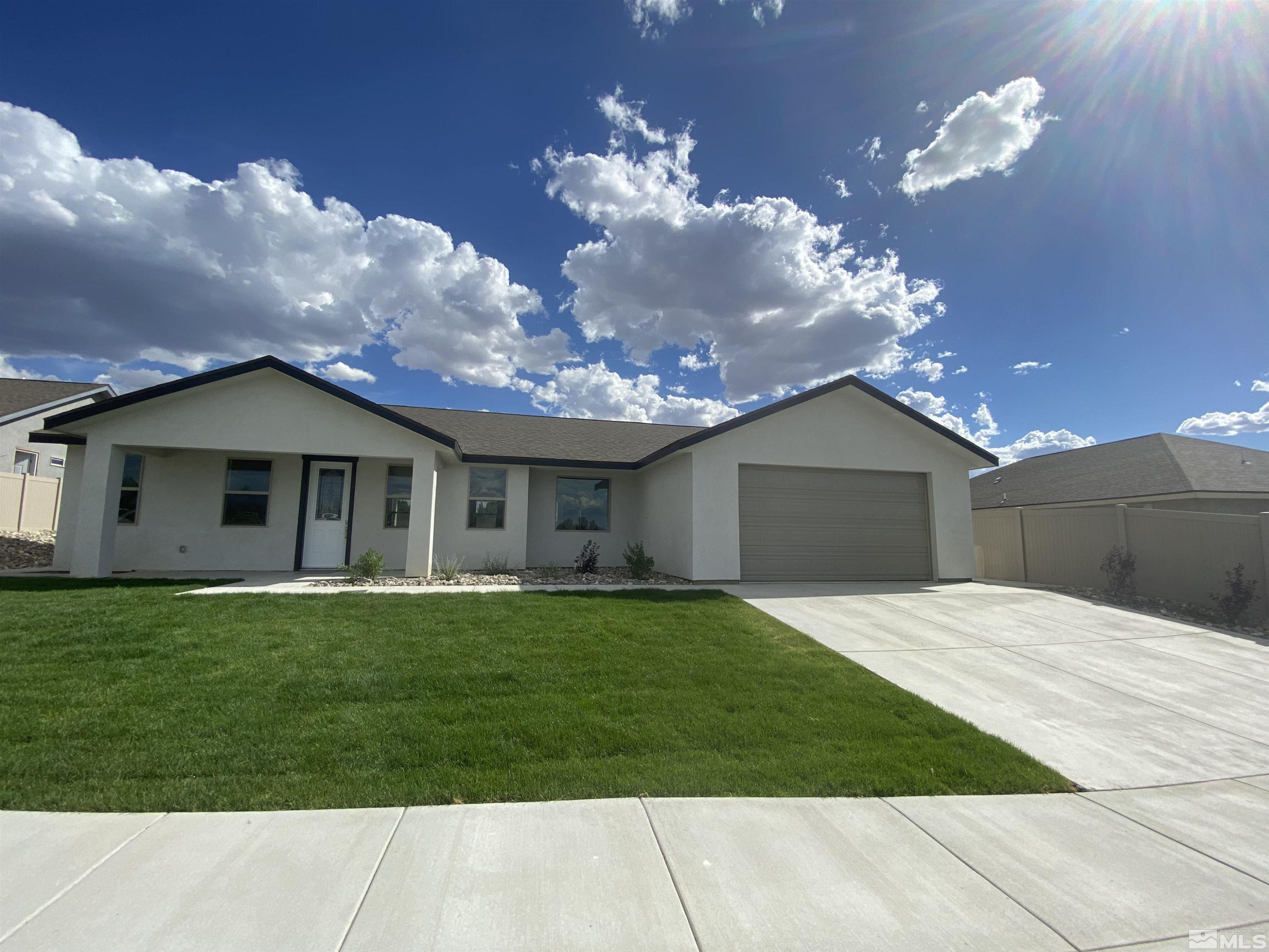 5950 Packsaddle Road Winnemucca, NV 89445 - Photo 14 of 14 a front view of a house with a garden and yard