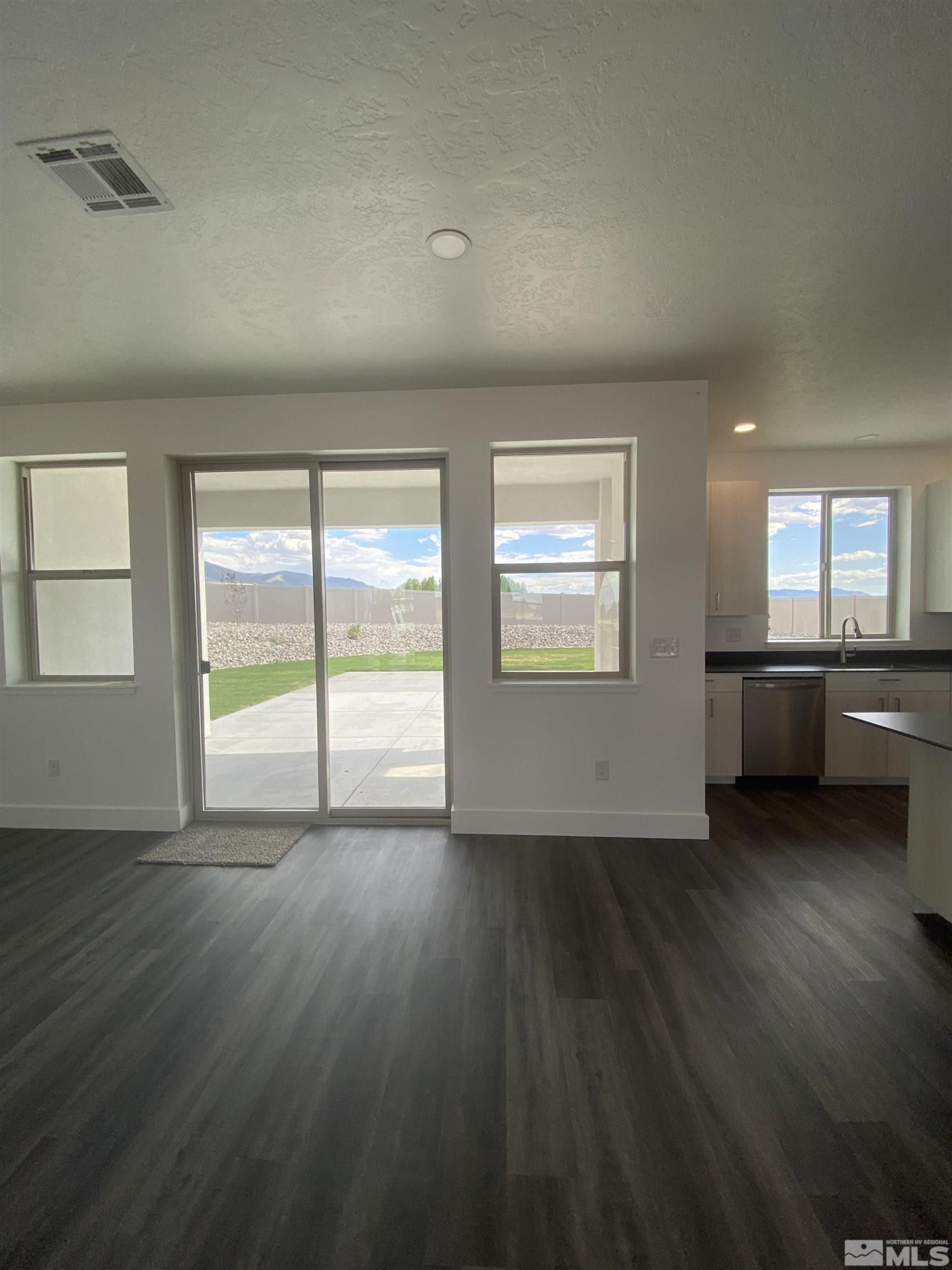 5950 Packsaddle Road Winnemucca, NV 89445 - Photo 6 of 14 an empty room with wooden floor and windows