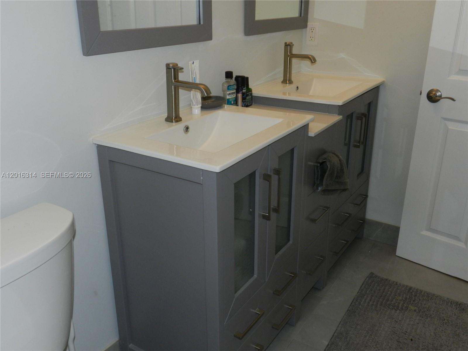 305 Northwest 42nd Street Boca Raton, FL 33431 - Photo 13 of 31 a bathroom with a sink a toilet and mirror
