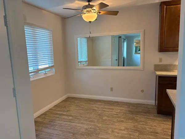 a view of empty room with window and fireplace