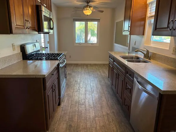 a kitchen with a sink a window and appliances