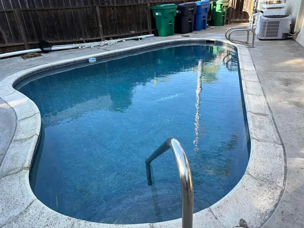 a view of a swimming pool with sitting area