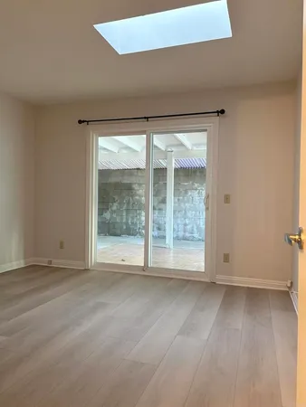 an empty room with large windows