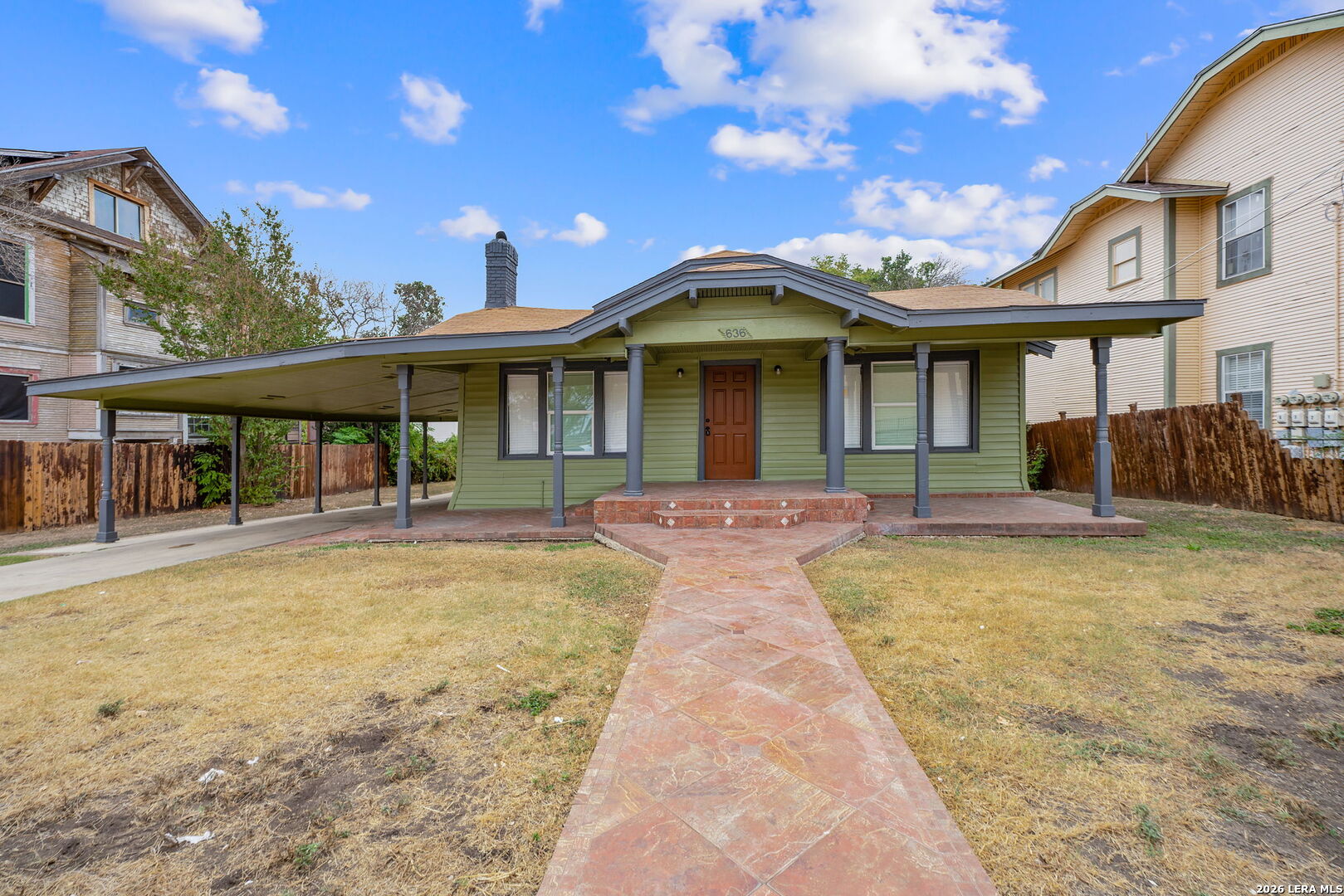 a front view of a house with swimming pool having outdoor seating