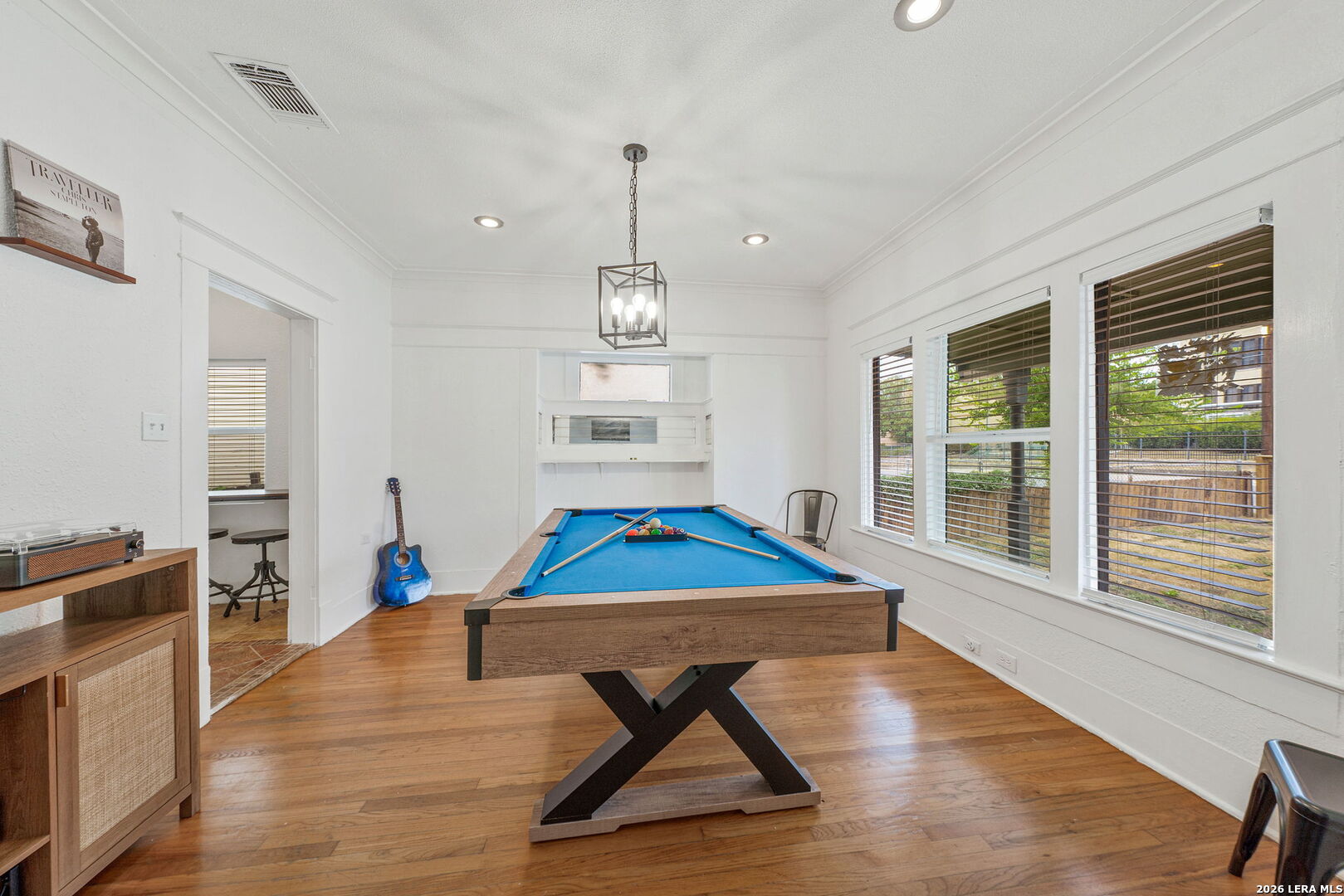 636 Rigsby Avenue San Antonio, TX 78210 - Photo 11 of 23 a room with wooden floor pool table and windows