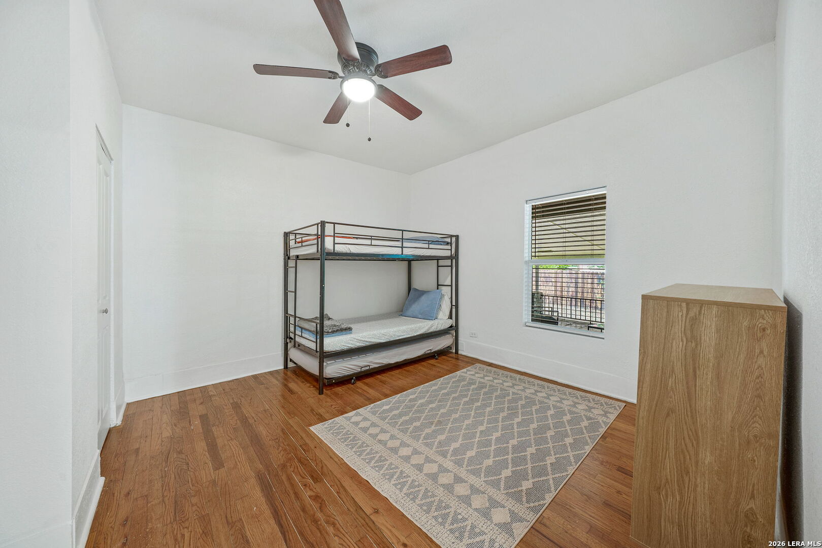 636 Rigsby Avenue San Antonio, TX 78210 - Photo 12 of 23 a bedroom with a bed and a window