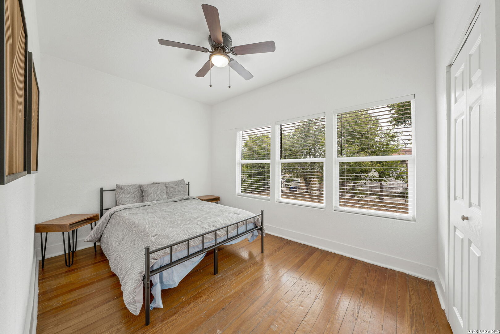 636 Rigsby Avenue San Antonio, TX 78210 - Photo 14 of 23 a bedroom with a bed next to a window with a chandelier