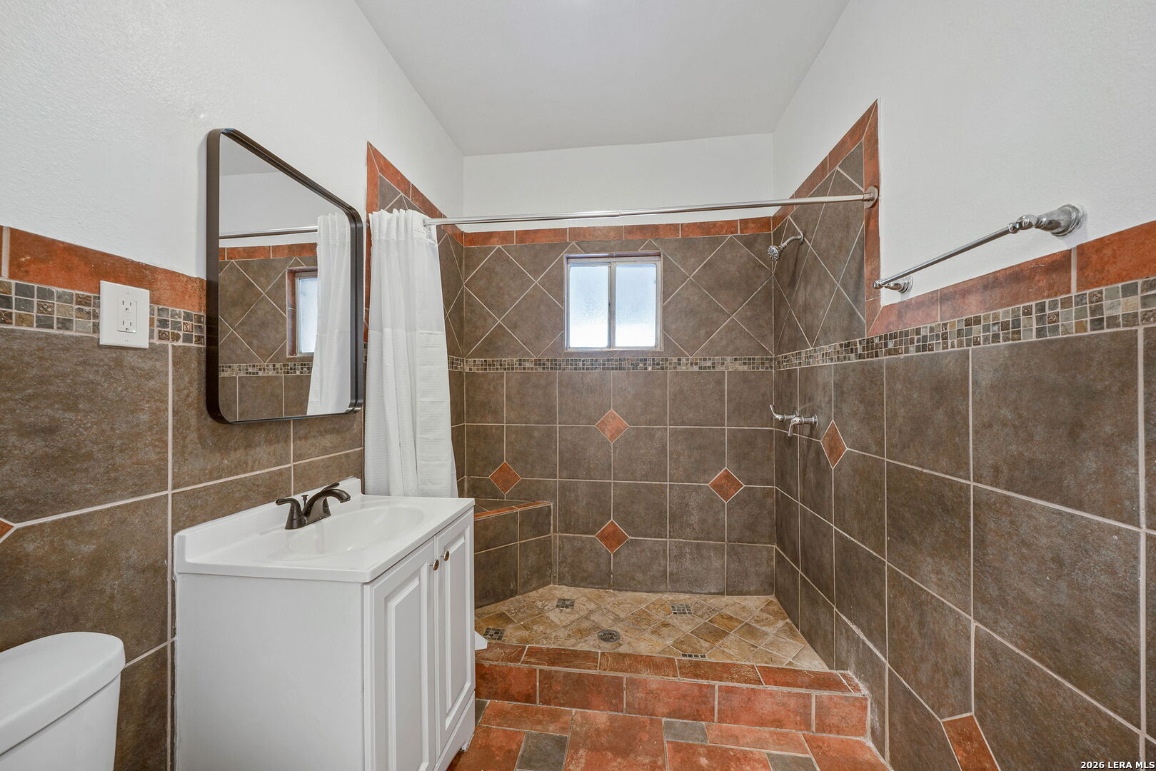 636 Rigsby Avenue San Antonio, TX 78210 - Photo 15 of 23 a bathroom with a sink mirror and shower