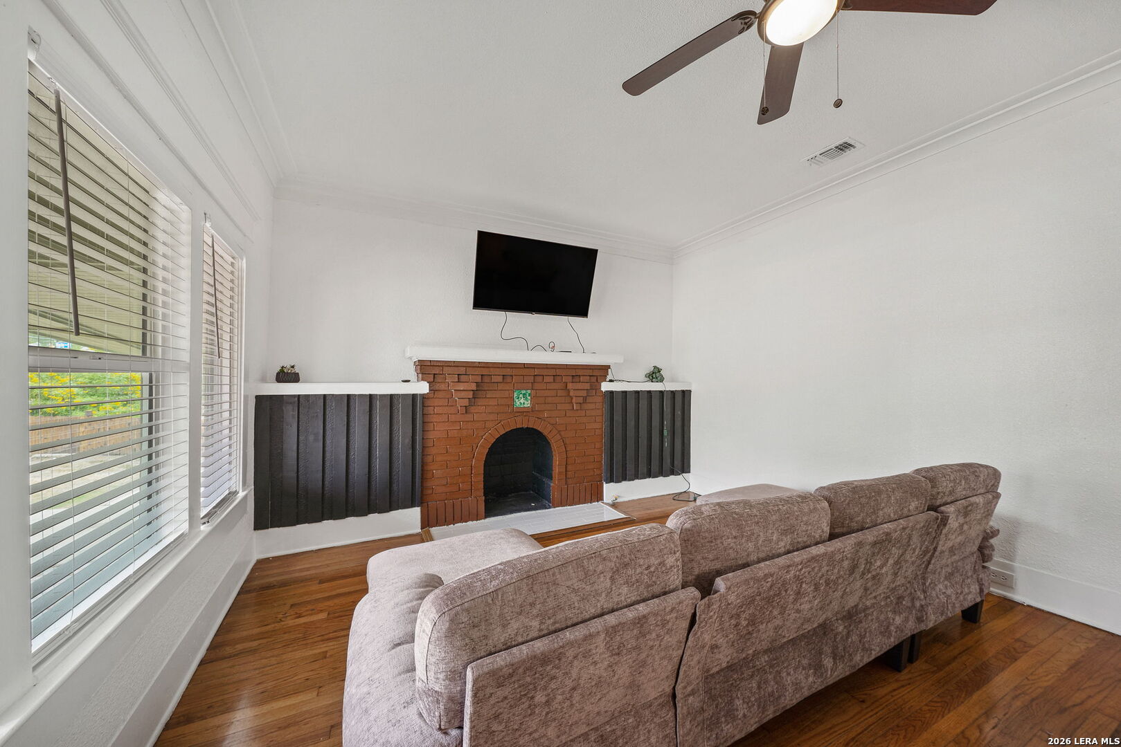 636 Rigsby Avenue San Antonio, TX 78210 - Photo 6 of 23 a living room with a couch and a flat screen tv