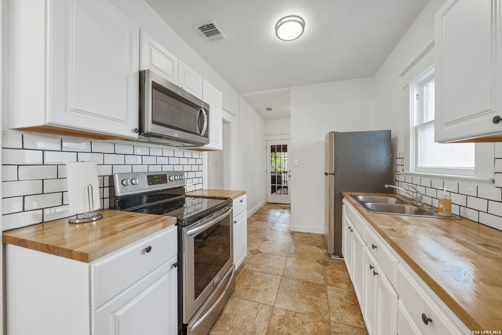 636 Rigsby Avenue San Antonio, TX 78210 - Photo 8 of 23 a kitchen with a sink stove and refrigerator