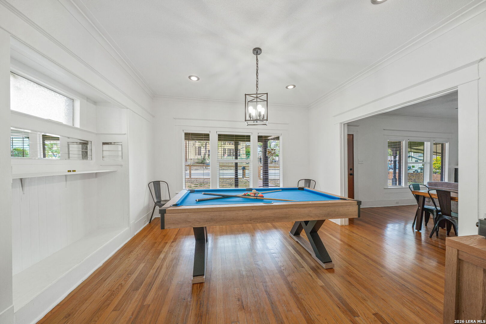 636 Rigsby Avenue San Antonio, TX 78210 - Photo 10 of 23 a view of a dining room with furniture wooden floor and a chandelier