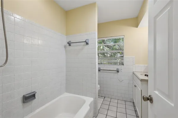 a bathroom with a granite countertop sink and a shower