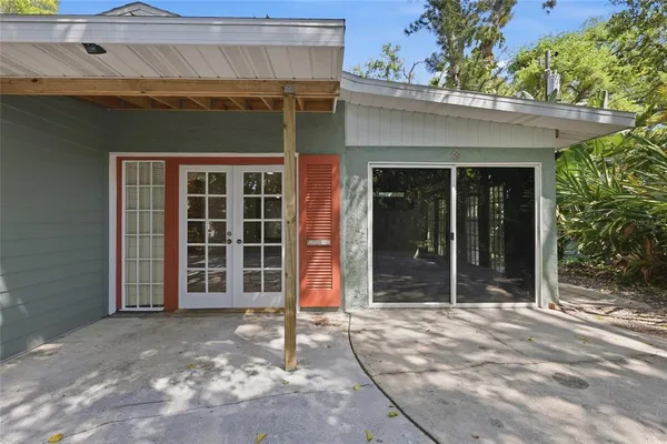 a bathroom with a granite countertop sink a mirror and a toilet