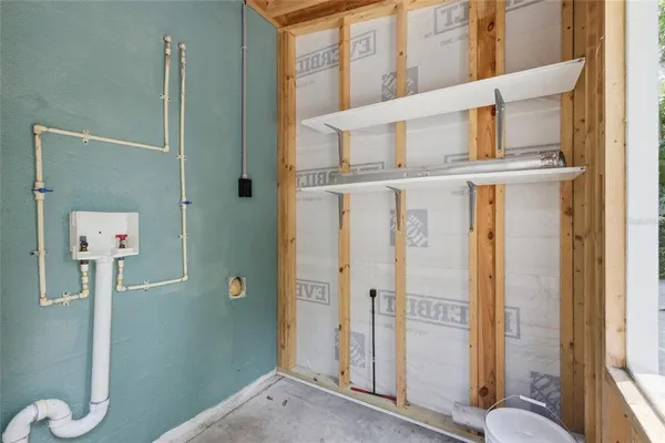 a view of a chair and table in the backyard