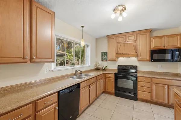 a kitchen with a sink and large window