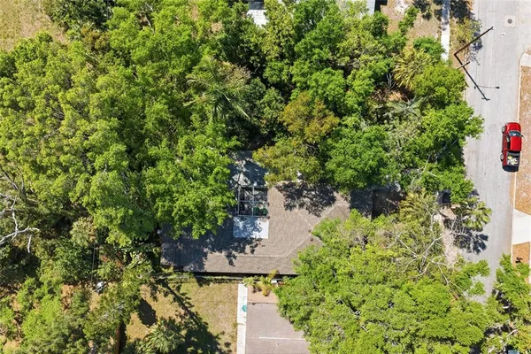 an aerial view of a house with a yard lake and city view