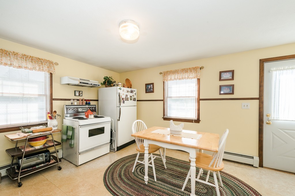 62 Beach Road Salisbury, MA 01952 - Photo 11 of 20 a workspace with furniture a window and a refrigerator