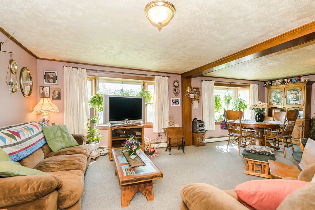 62 Beach Road Salisbury, MA 01952 - Photo 6 of 20 a living room with furniture and a flat screen tv with wooden floor