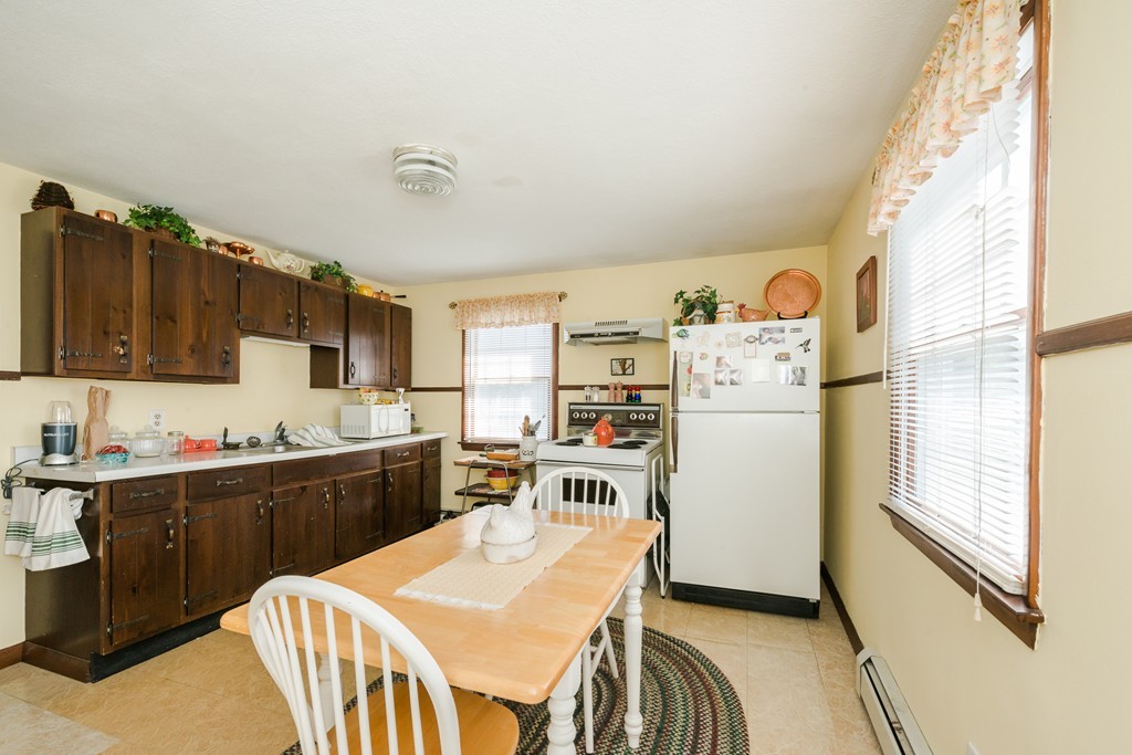 62 Beach Road Salisbury, MA 01952 - Photo 10 of 20 a kitchen with refrigerator cabinets and wooden floor