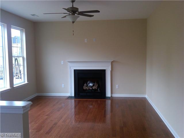3148 Cranberry Ridge Drive High Point, NC 27265 - Photo 7 of 10 Den/Family/Great Room. Kitchen opens to large Family Room with great windows, gas fireplace, fan with light kit and wood floors.