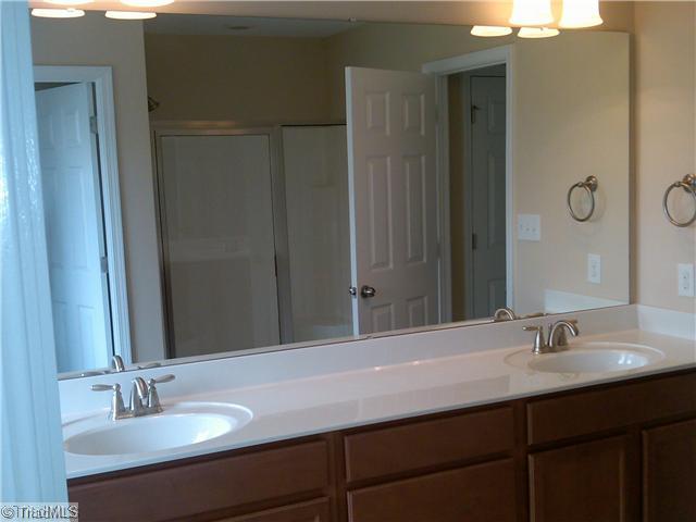 3148 Cranberry Ridge Drive High Point, NC 27265 - Photo 8 of 10 Master Bath/Spa. Roomy Master Bath features long double vanity with Moen brushed nickel fixtures, maple cabinets, brushed nickel vanity lighting, ceramic floors and tile surround at master tub. Large separate Master shower with glass door.