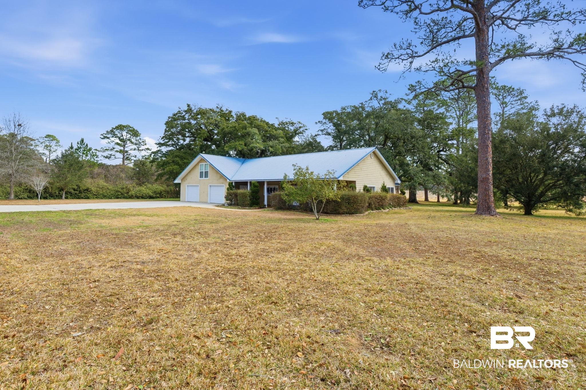 15025 Bellingrath Road Coden, AL 36523 - Photo 5 of 79 Single story home with a front lawn, driveway, and an attached garage