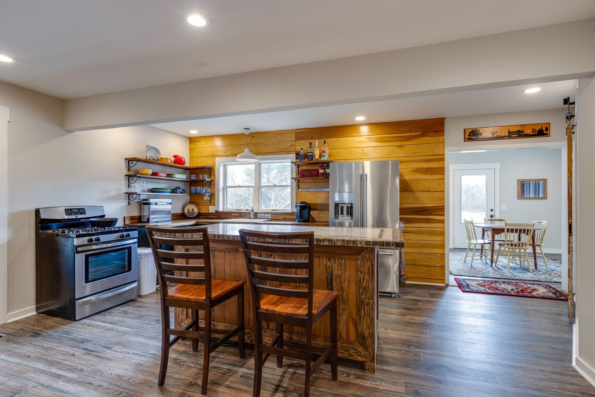 3111 Lewis Road Santa Fe, TN 38482 - Photo 12 of 40 a kitchen with stainless steel appliances wooden floor dining table and chairs