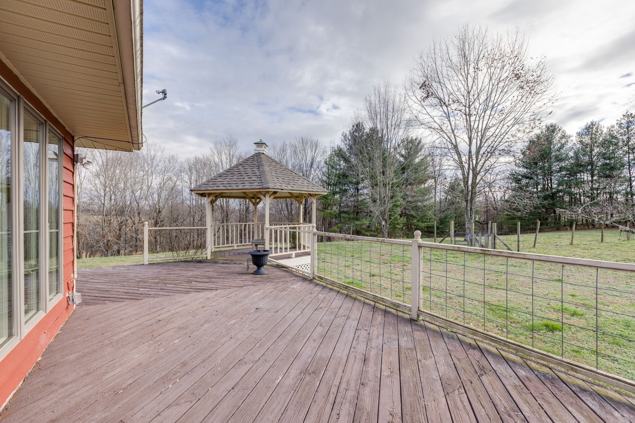 3111 Lewis Road Santa Fe, TN 38482 - Photo 31 of 40 a view of a deck with a table and chairs under an umbrella with wooden floor