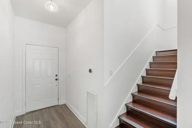 a view of entryway with wooden floor