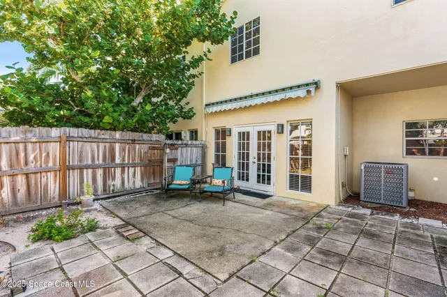 a view of a house with backyard porch and sitting area