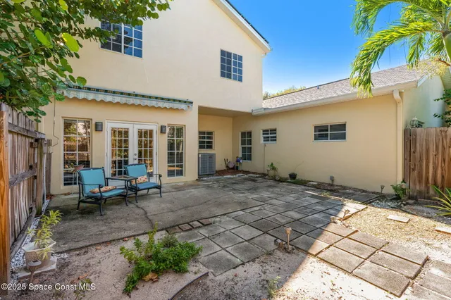 a view of a house with backyard and sitting area