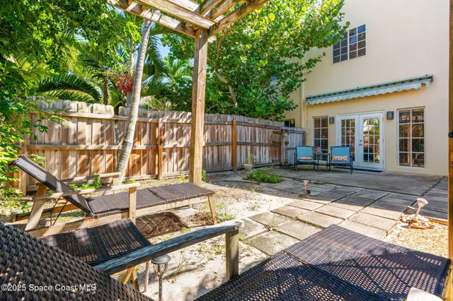 a view of a house with backyard and sitting area