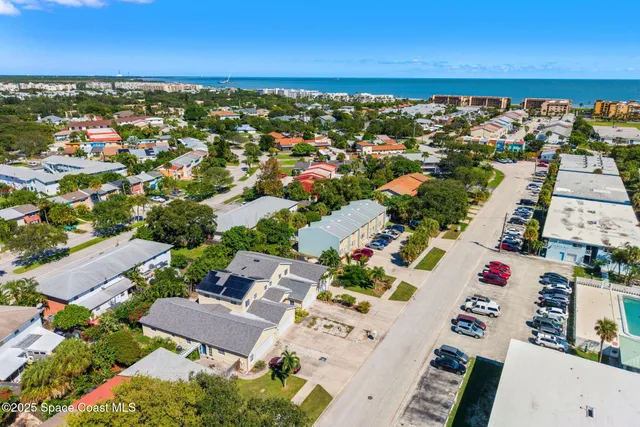 an aerial view of residential houses with outdoor space