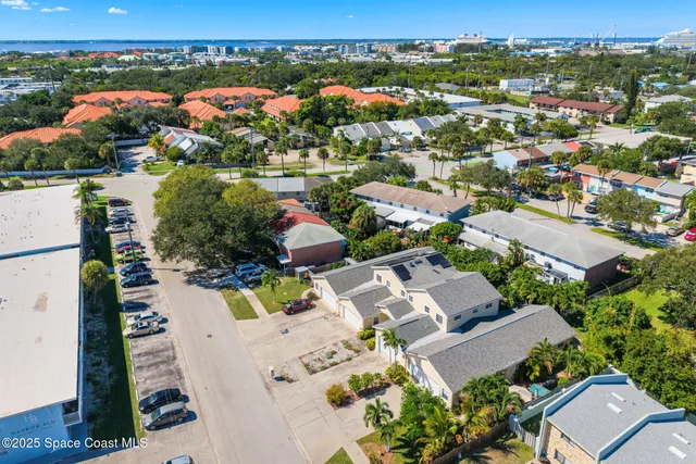 an aerial view of residential houses with outdoor space