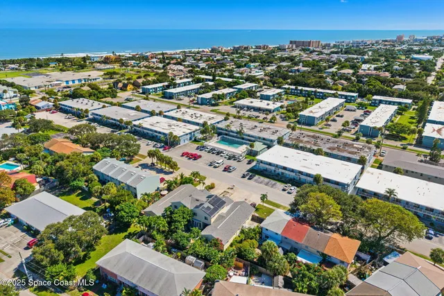 an aerial view of residential houses with outdoor space